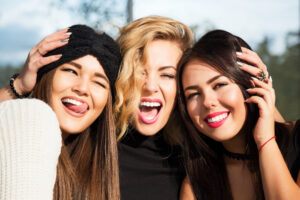 women smiling with confidence after cosmetic dentistry